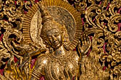 Wat Xieng Thong temple in Luang Prabang, Laos. Detail of the  gilded wood carvings of the facade of the Royal Funerary carriage hall. 